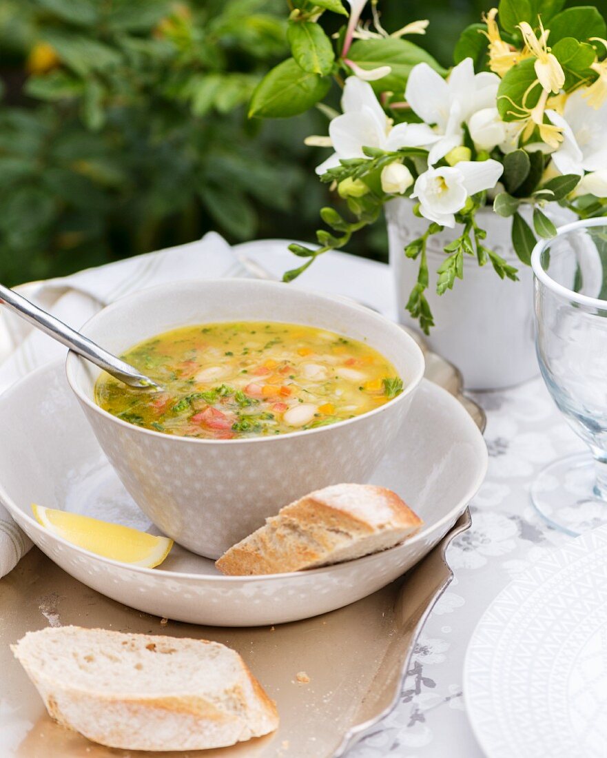 Vegetable soup with pasta, pesto and lemons