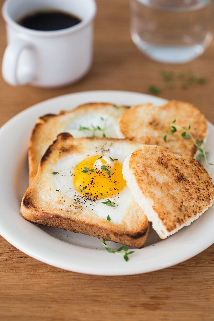 A heart-shaped fried egg in a slice of a toast