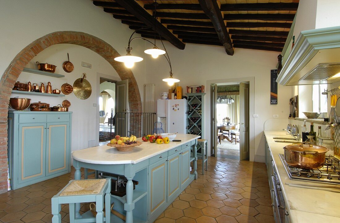 Large, country-house-style Mediterranean kitchen with terracotta floor tiles