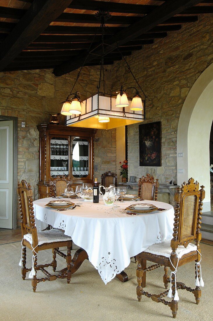 Antique furniture and stone walls in Mediterranean dining room