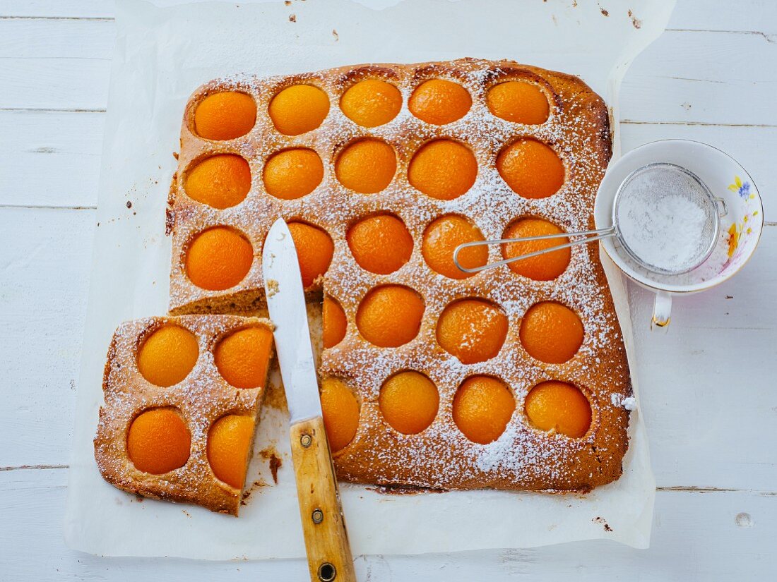 An apricot tray bake cake with icing sugar