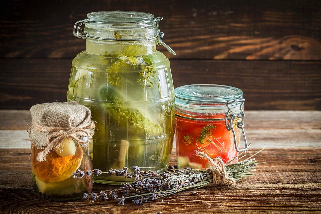 Pickled cucumbers, tomatoes and mushrooms in jars