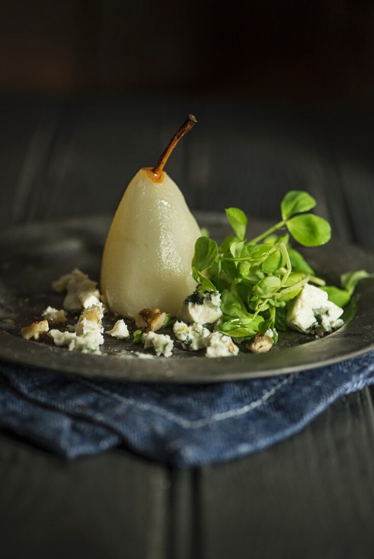 A poached pear with blue cheese and basil