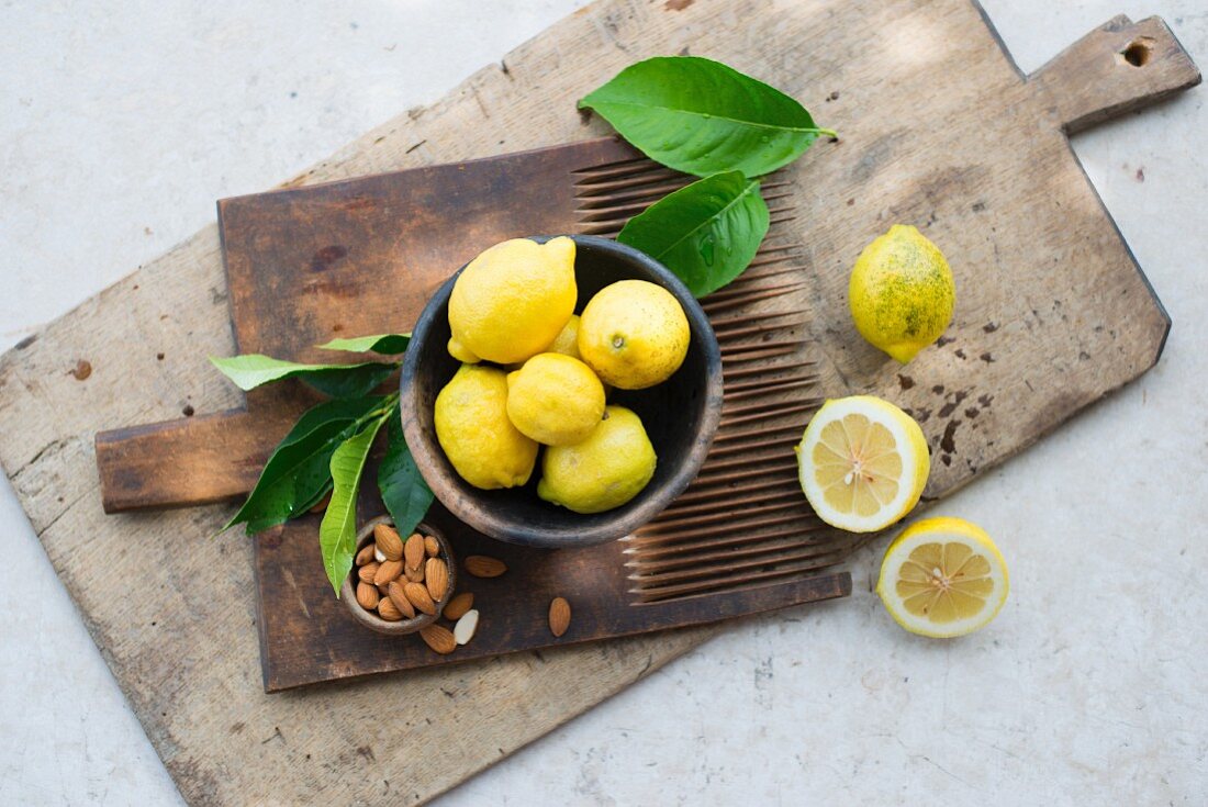 Lemons and almonds on a wooden board