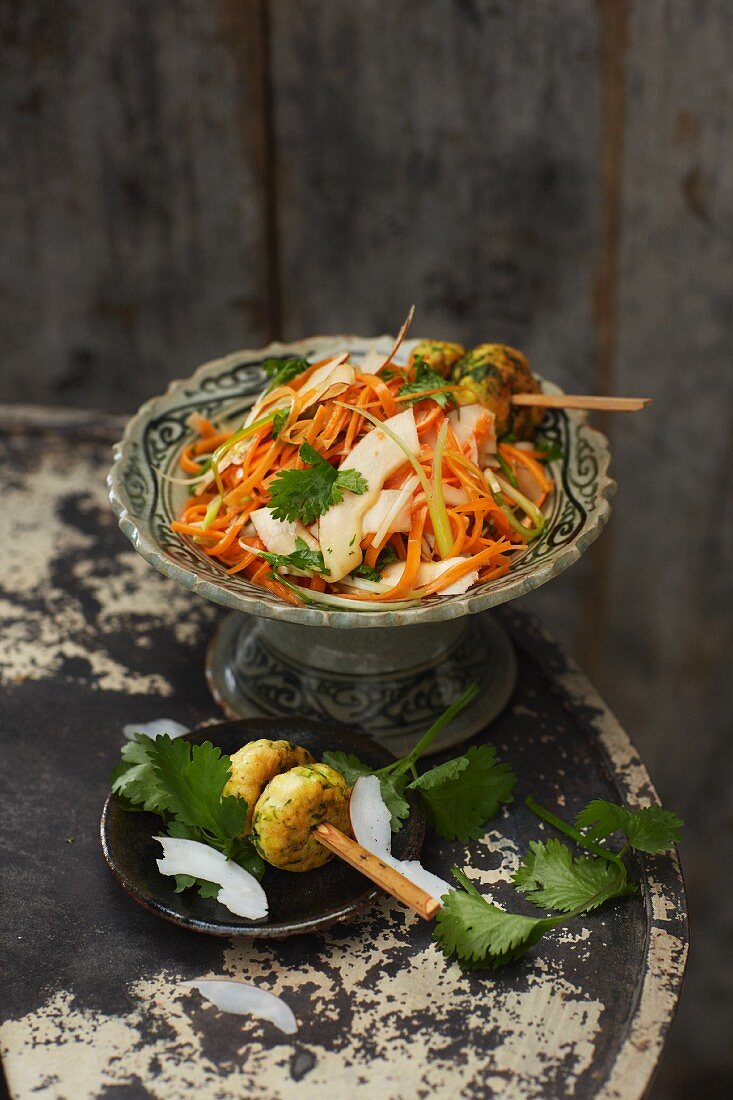 Coconut and carrot salad with chicken skewers