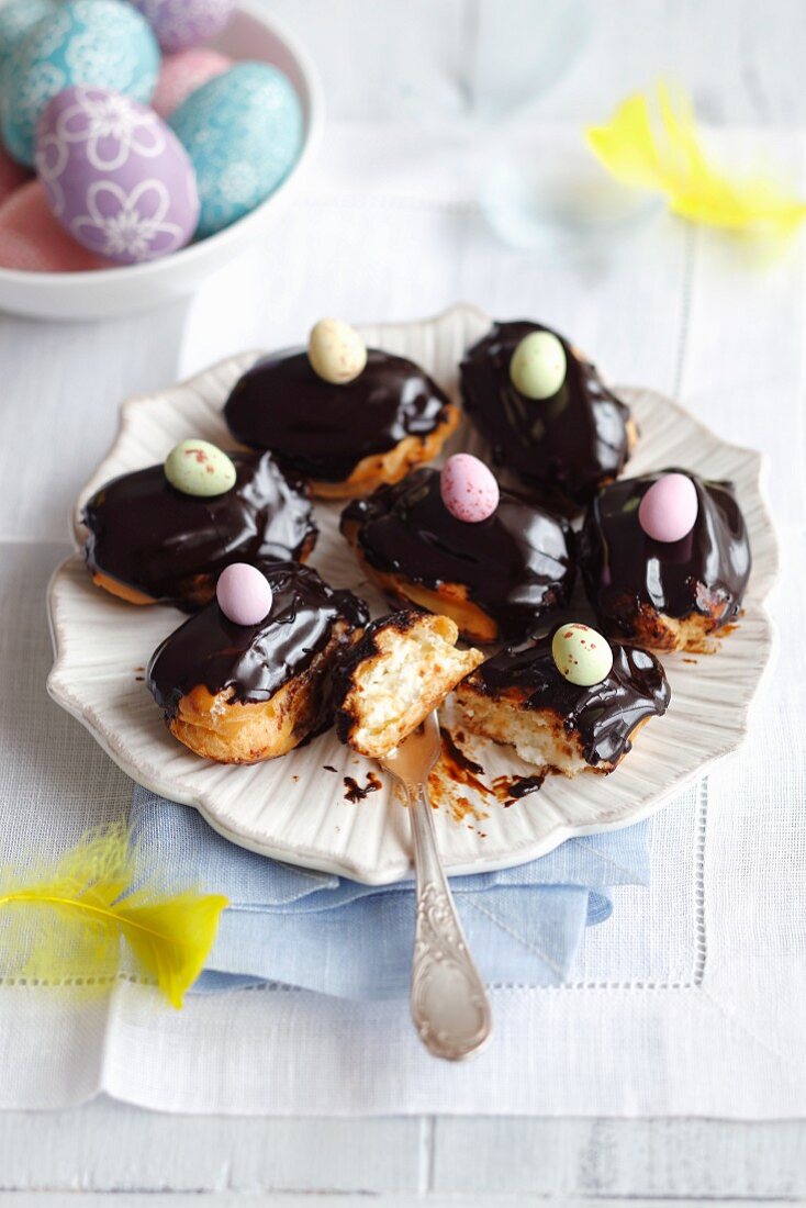 Mini eclairs with whipped cream and chocolate glaze for Easter