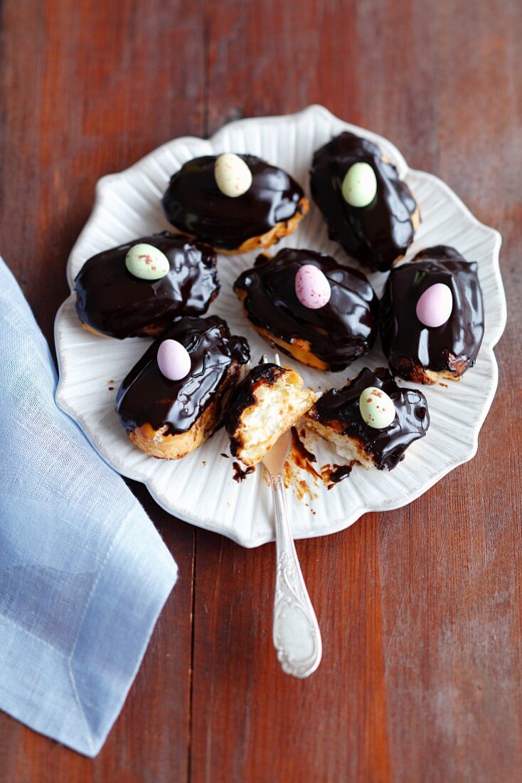 Mini eclairs with whipped cream and chocolate glaze for Easter