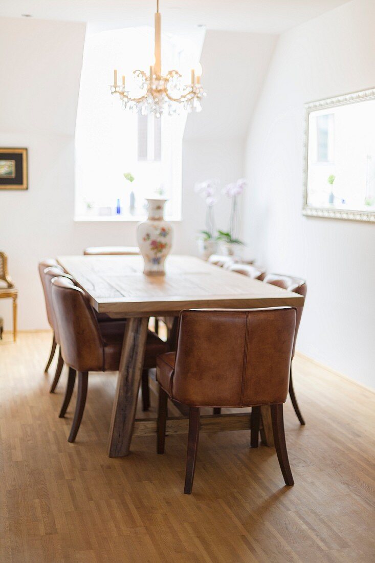 Wooden table and leather-covered chairs in classic dining room