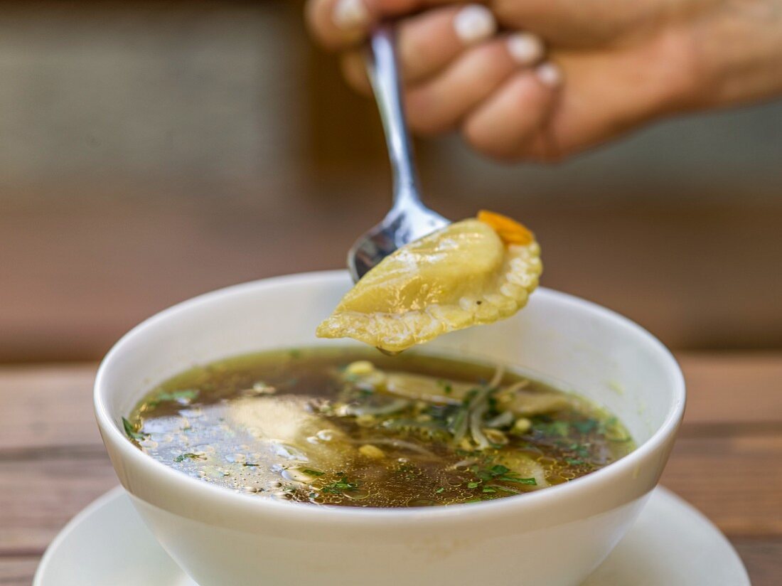 Clear broth with momos (dumplings from Nepal)