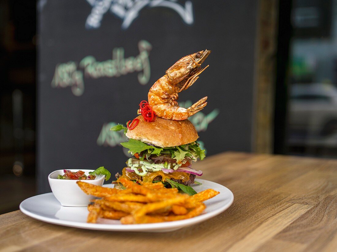 A giant burger with a prawn in a restaurant