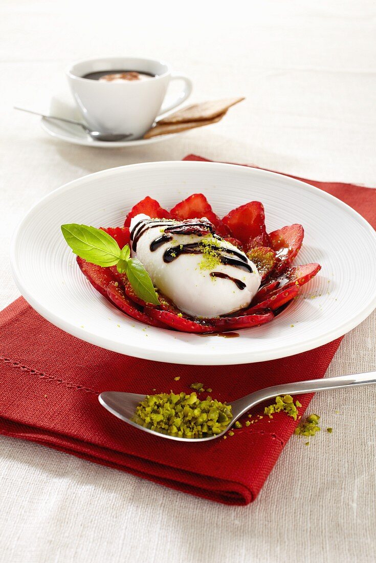 Mozzarella with balsamic cream on a strawberry carpaccio