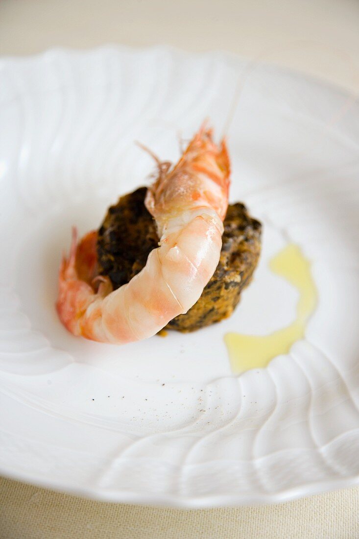 Sparnocchi con lardo di Colonnata e farinata di cavolo nero (a prawn canapé with lardo and black kale, Italy)