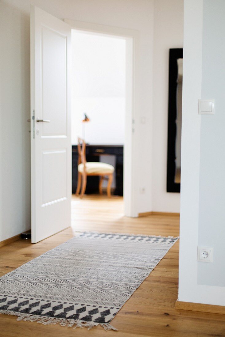 Rug with ethnic black and white print in hallway