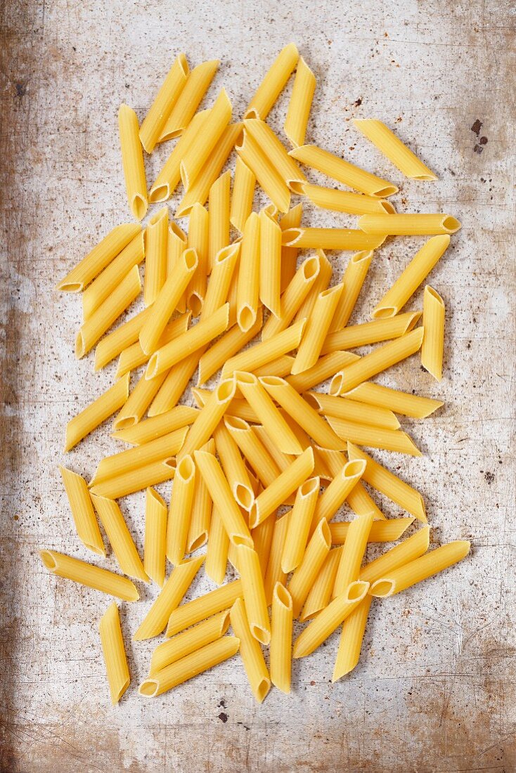 Penne rigate on a grey surface