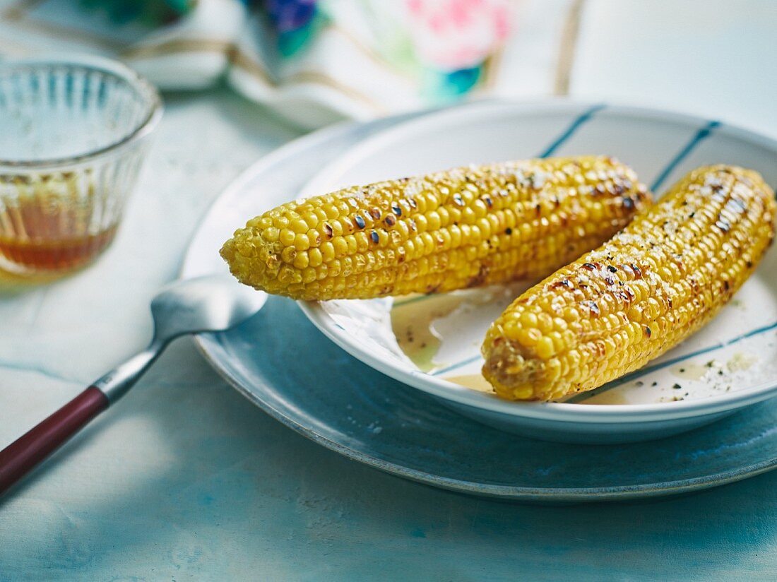 Grilled corn cobs in a rum marinade