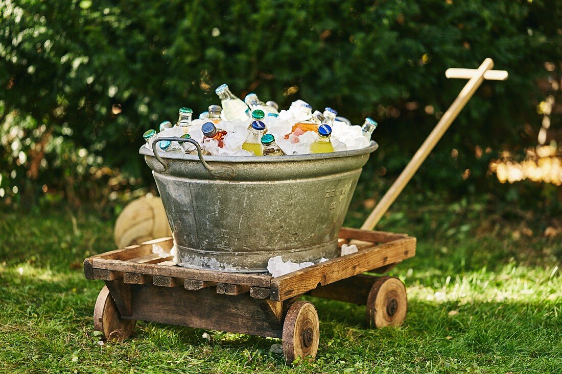 A zinc bathtub filled with chilled drinks for a garden party