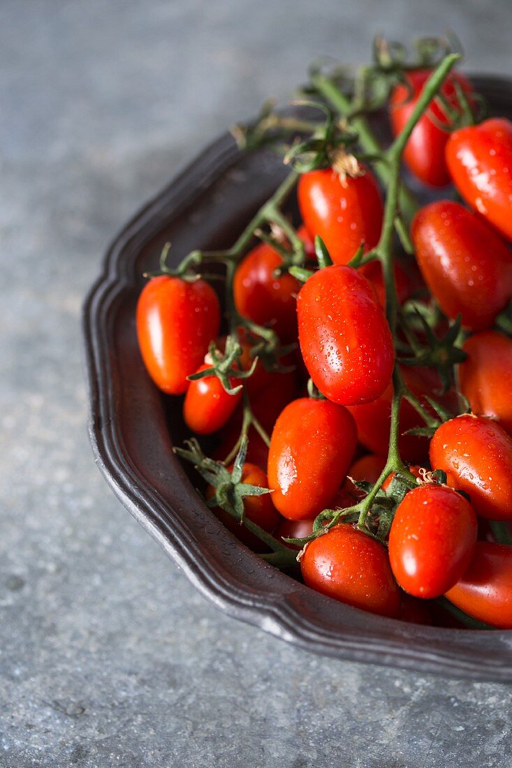 A bowl of fresh vine tomatoes