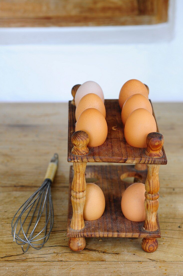 Fresh eggs on a wooden rack