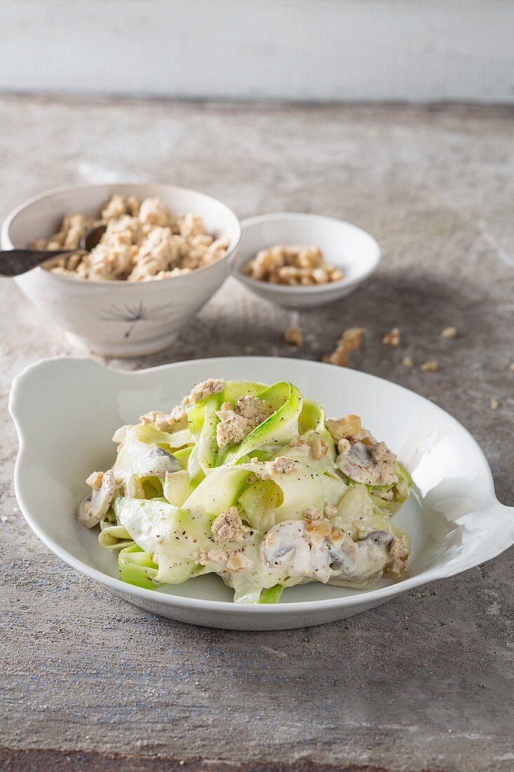 Courgette pasta with tofu cheese, mushrooms and walnuts