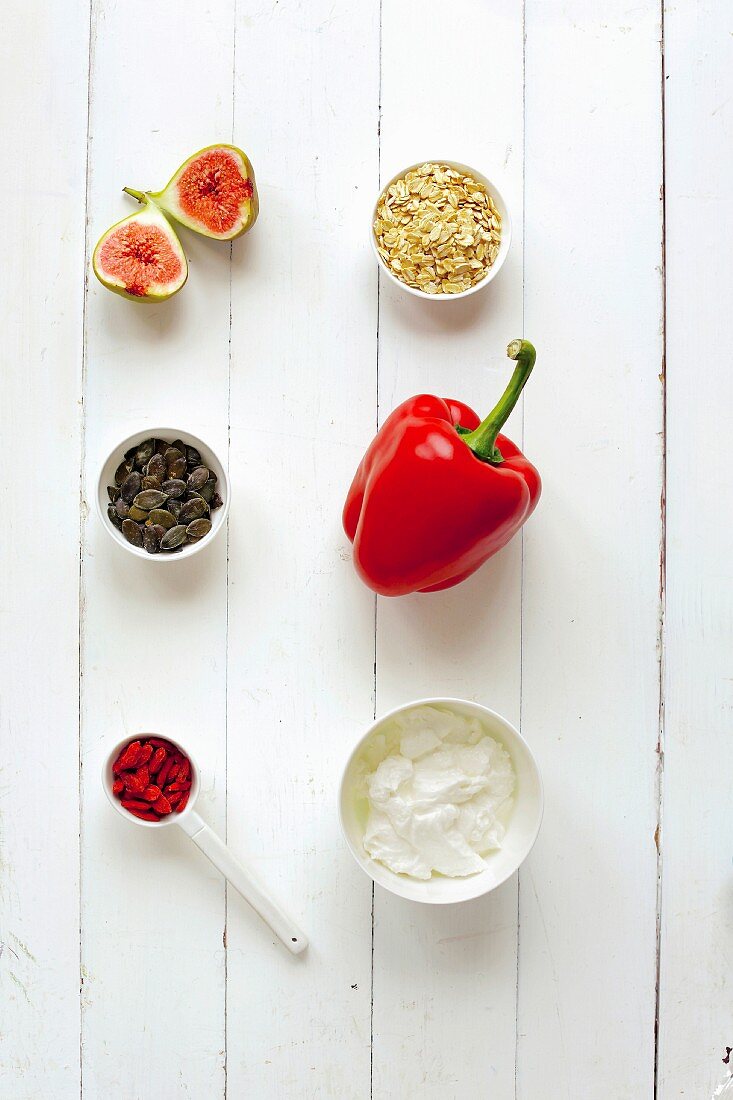 Ingredients for muesli on a white wooden surface