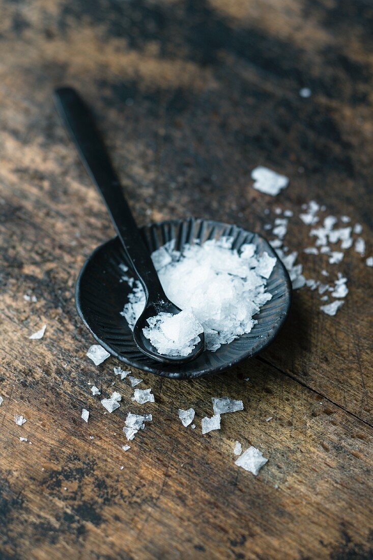 Salt flakes in a dish with a spoon