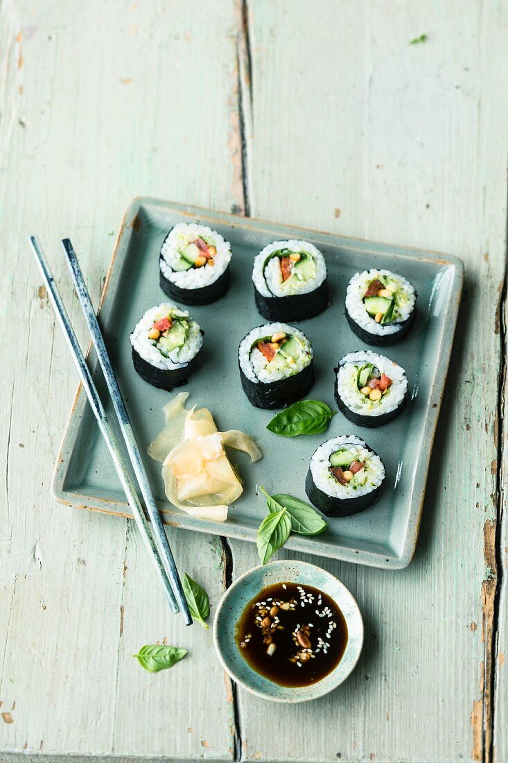 Vegetarian tomato and cucumber sushi with pine nuts