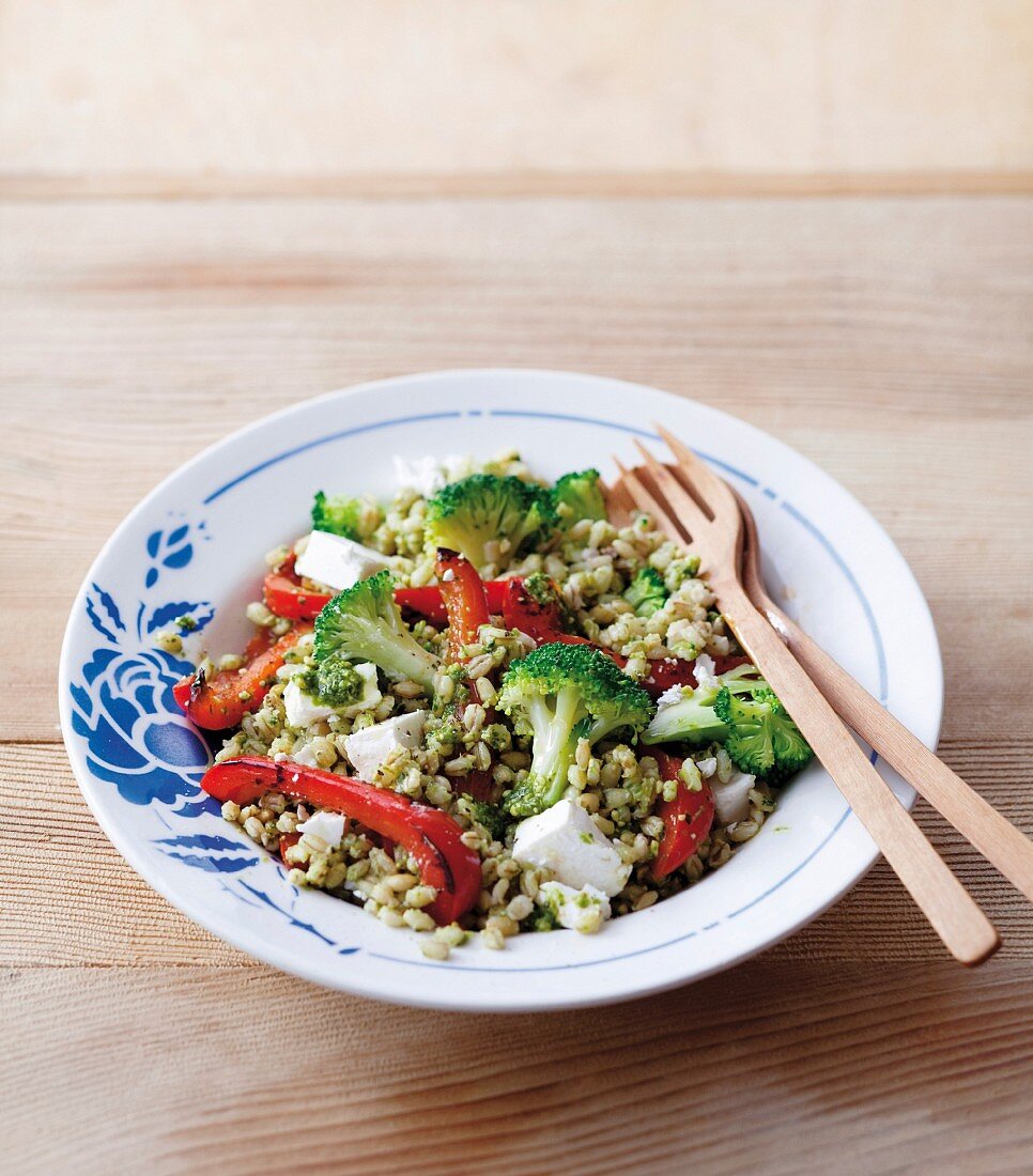 Barley salad with red peppers, broccoli, feta cheese and a pesto dressing