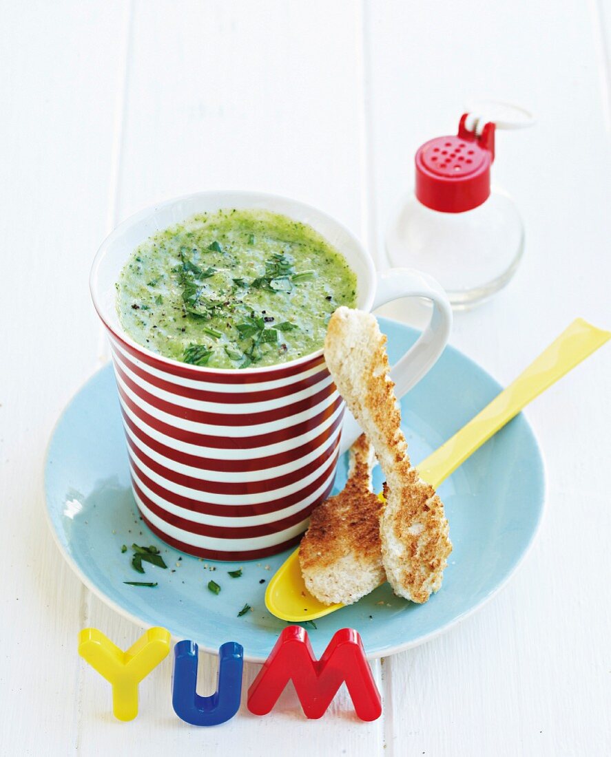 Broccoli soup with Cheddar cheese and toast spoons