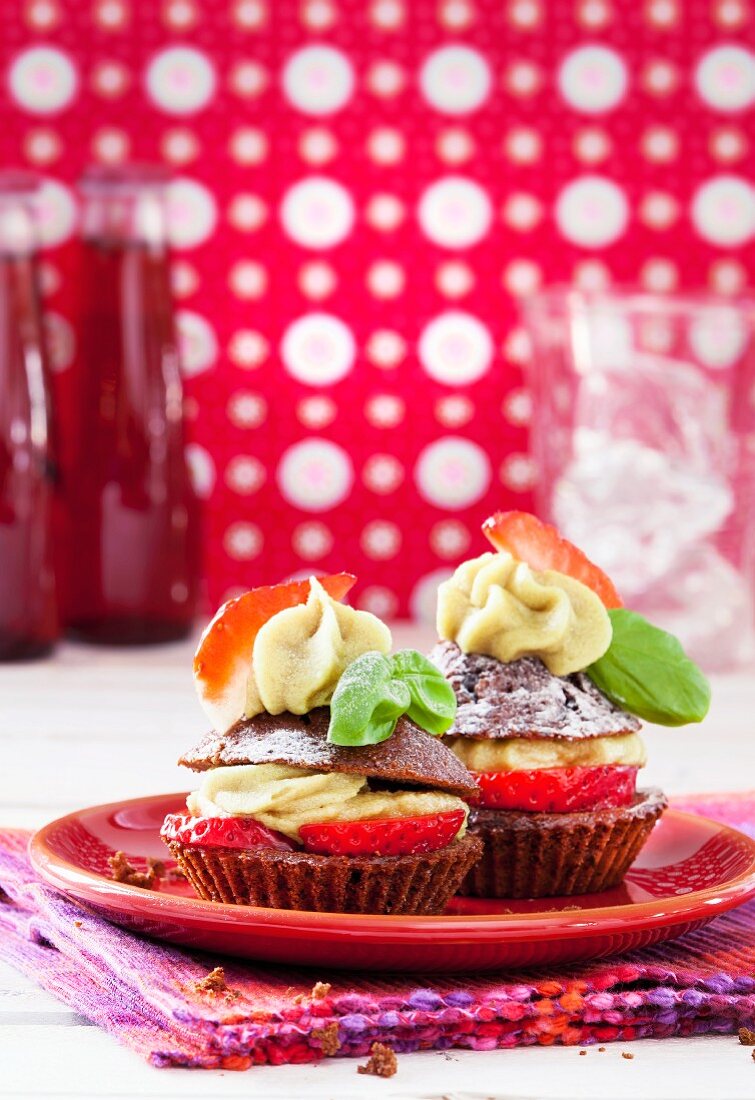 Strawberry and chocolate cupcakes with a lime and basil topping