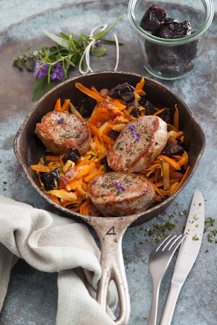 Fried pork medallions on a dried plum and carrot medley