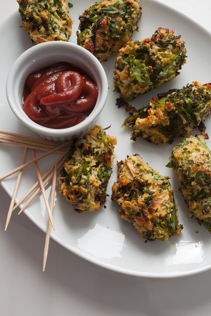 Baked broccoli bites with ketchup and toothpicks