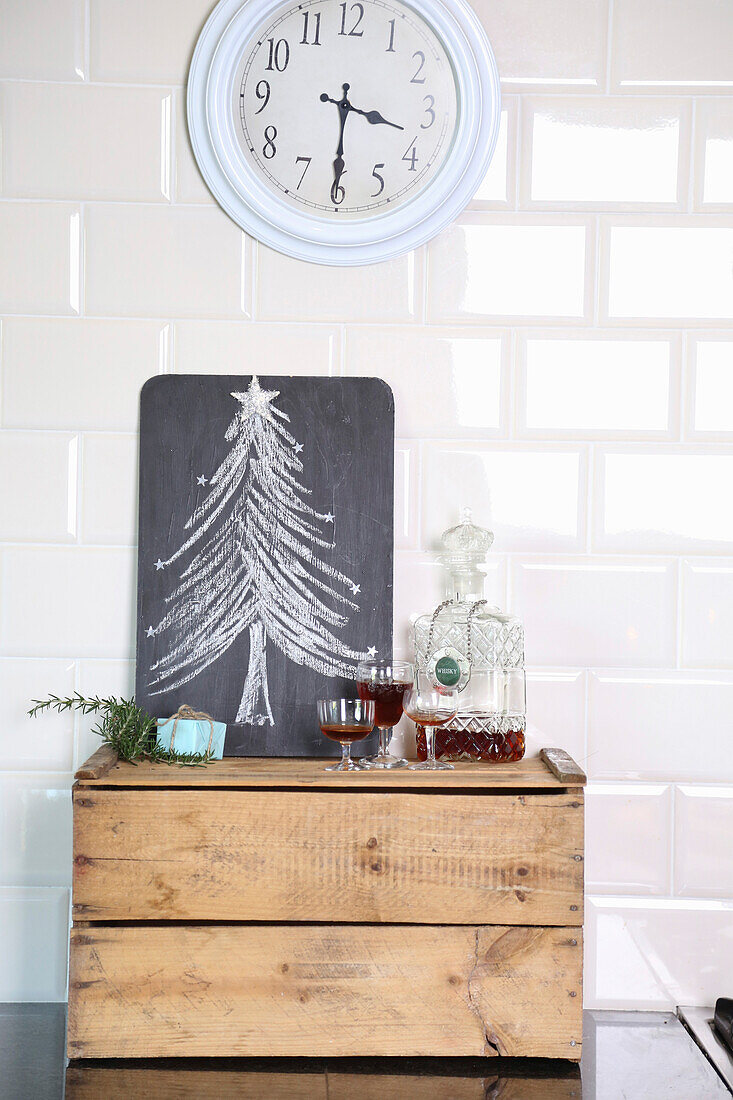 Kreidetafel mit Tannenbaum auf Holzkiste