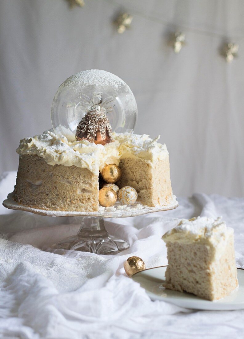 An angel cake with a snowglobe and brandy butter icing for Christmas