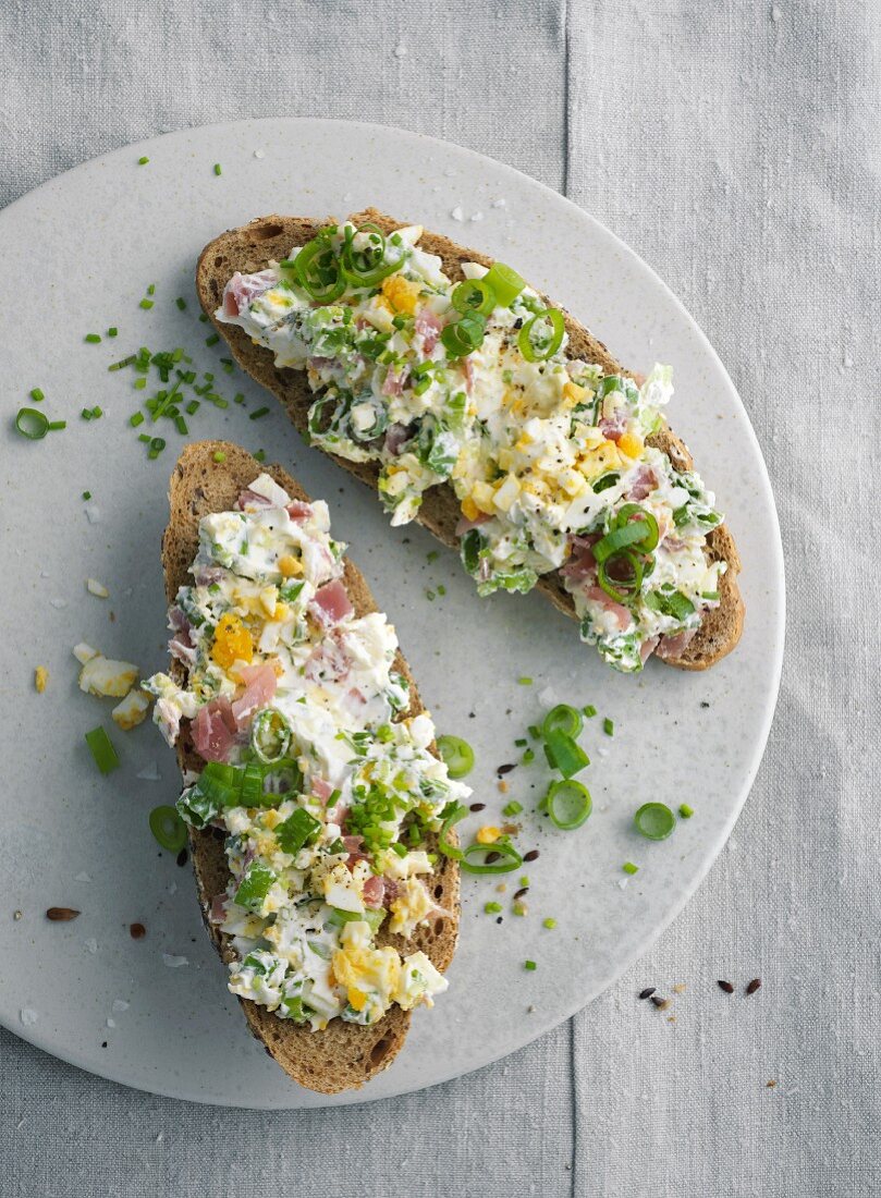 Bread topped with a ham and egg spread