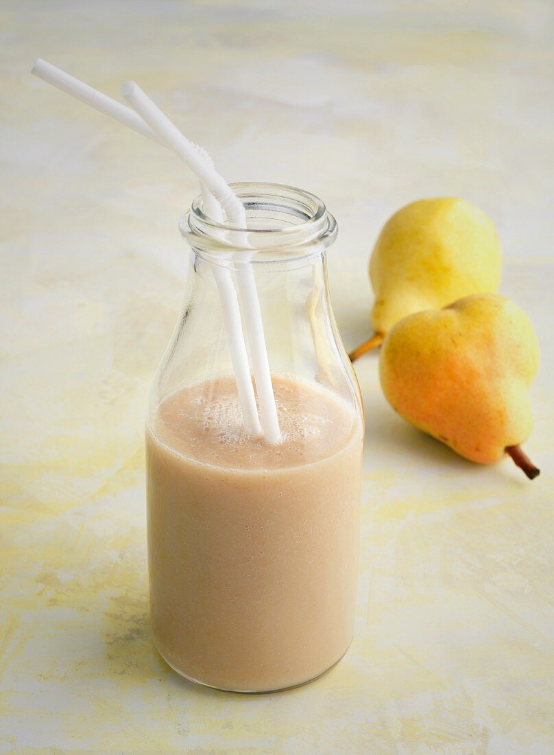 A pear smoothie and fresh pears