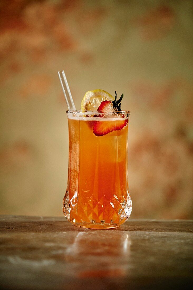 Kentucky Buck Cocktail made with strawberries, bourbon, lemon juice, bitters, ginger beer, a lemon slice and syrup