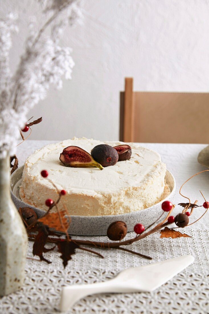Cake with figs on table with Christmas decorations
