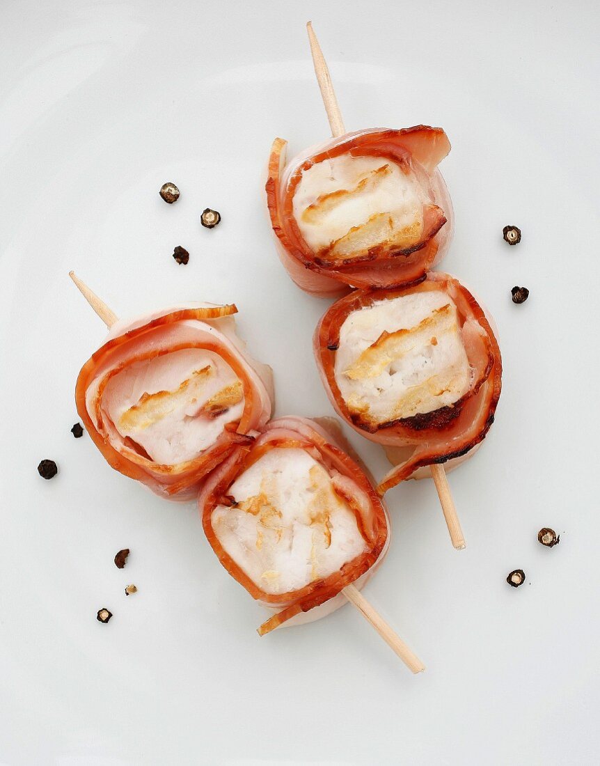 Grilled fish canapés wrapped in bacon