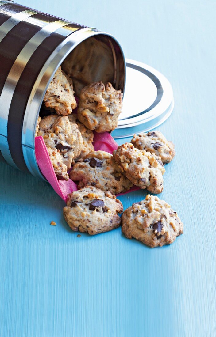 Chocolate Chip Walnut Cookies Piled on a Dish with Two on a Cloth Napkin