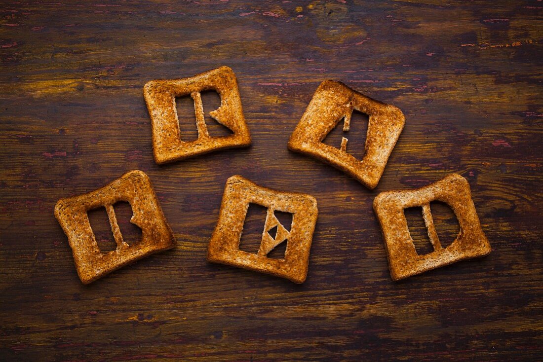 Letters cut out of slices of toast spelling the word 'bread'