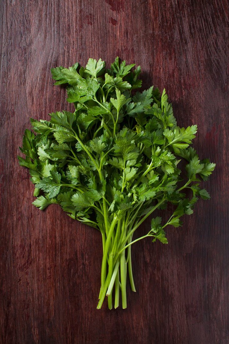A bunch of parsley on wooden surface