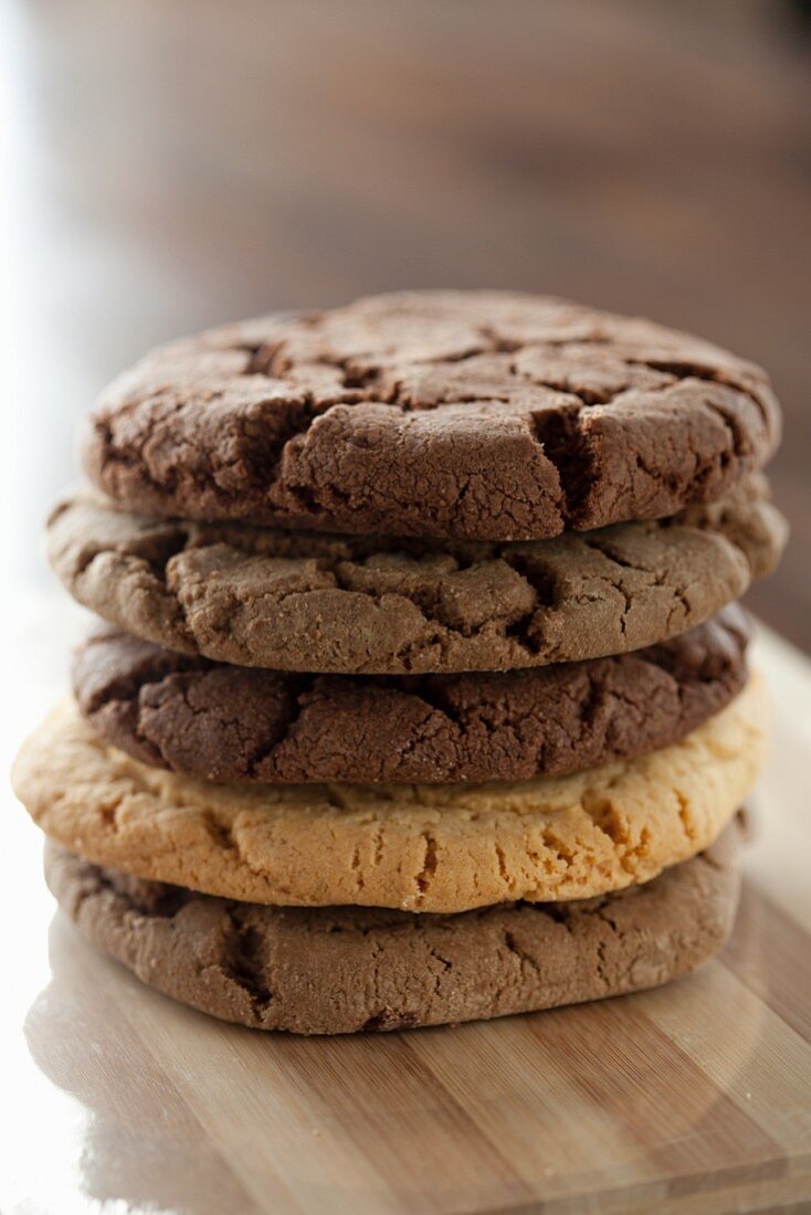 A stack of various chocolate chip cookies
