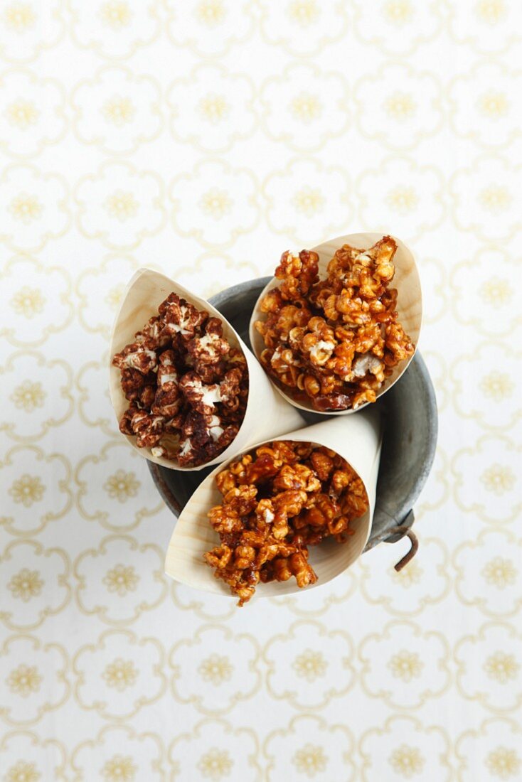 Caramel and chocolate popcorn in paper cones