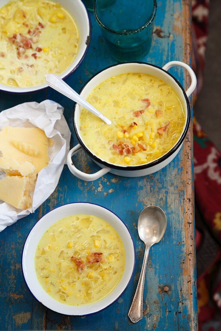 Thick corn soup and cheese on a blue wooden table