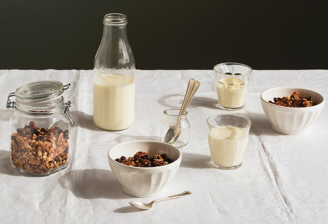 A breakfast table laid with muesli and milk