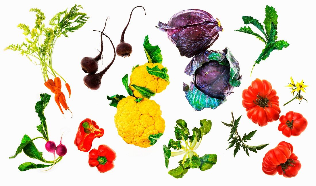 Various vegetables on a white surface (seen from above)