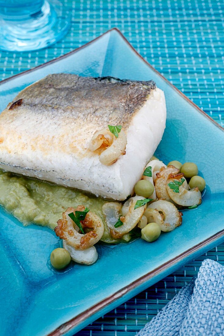 Baked hake with squid and mushy peas