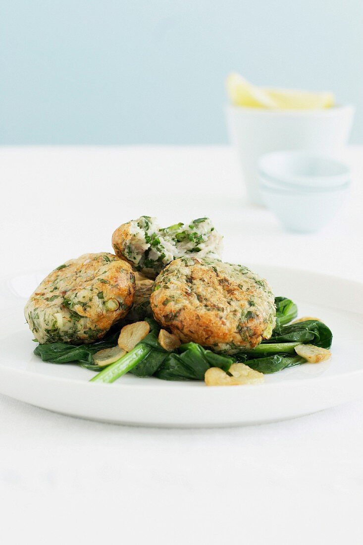 Fish cakes with garlic spinach