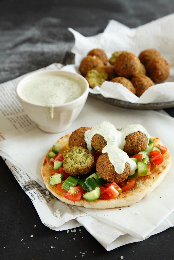 Falafel on pita bread with a vegetable salad and tahini
