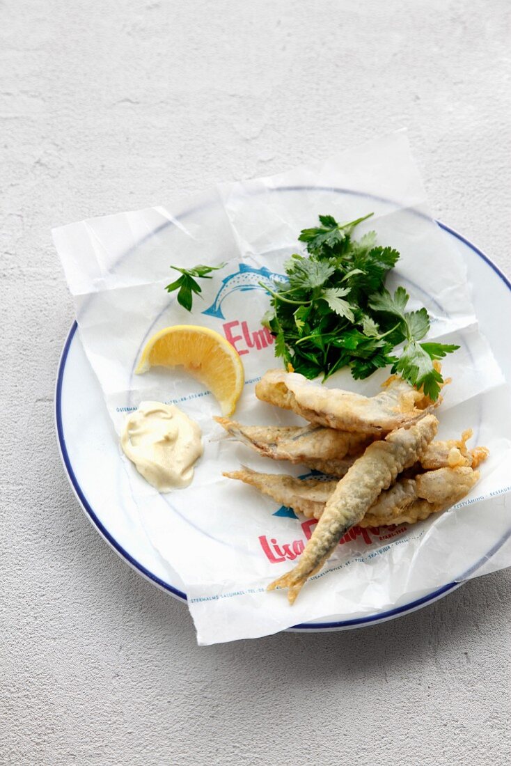 Fried breaded anchovies with mayonnaise and lemon